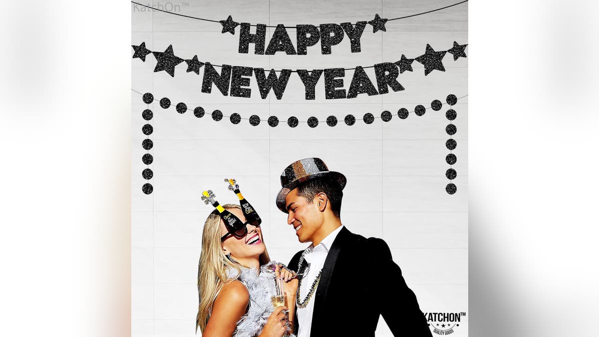 This black metallic Happy New Year sign will set the stage for your party.