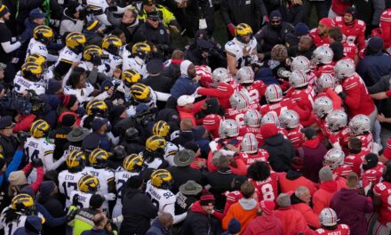 Group Of Players Kneel To Pray Together During Michigan-Ohio State Postgame Melee