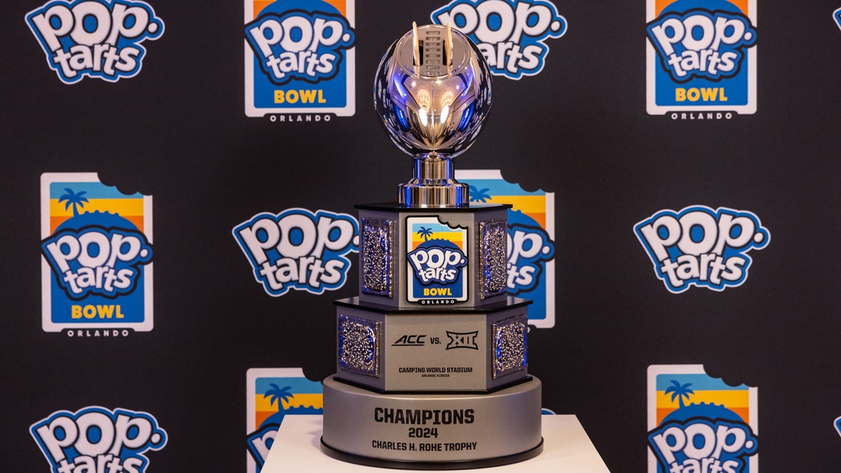 The Pop-Tarts Bowl trophy is shown with two breakfast pastries in the fully functional toaster shaped like a silver football.