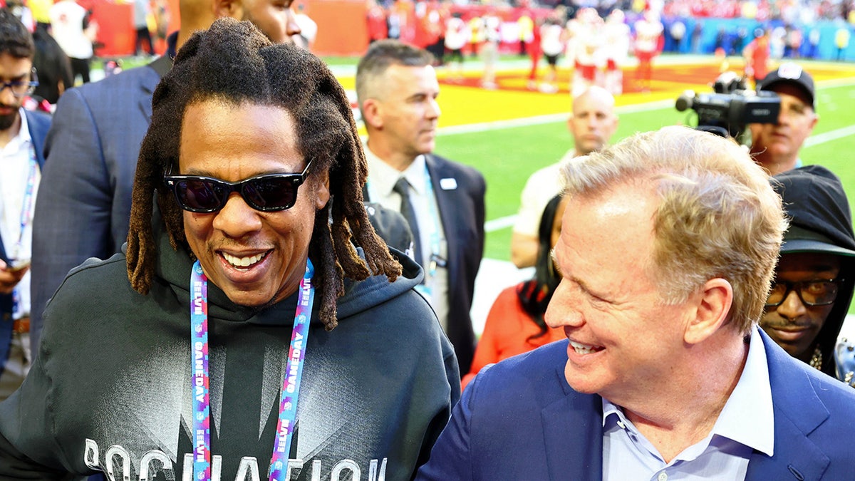 Roger Goodell stands next to Jay-Z before a game