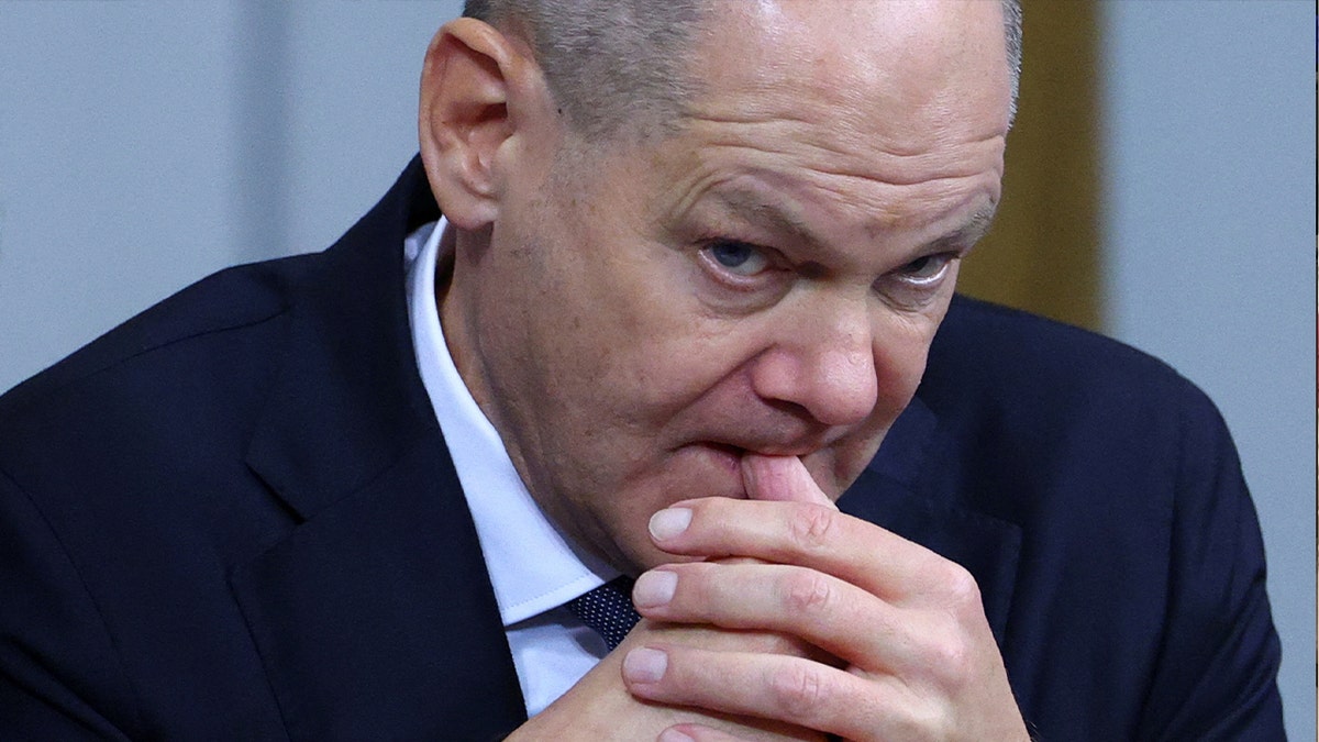 German Chancellor Olaf Scholz bites his finger