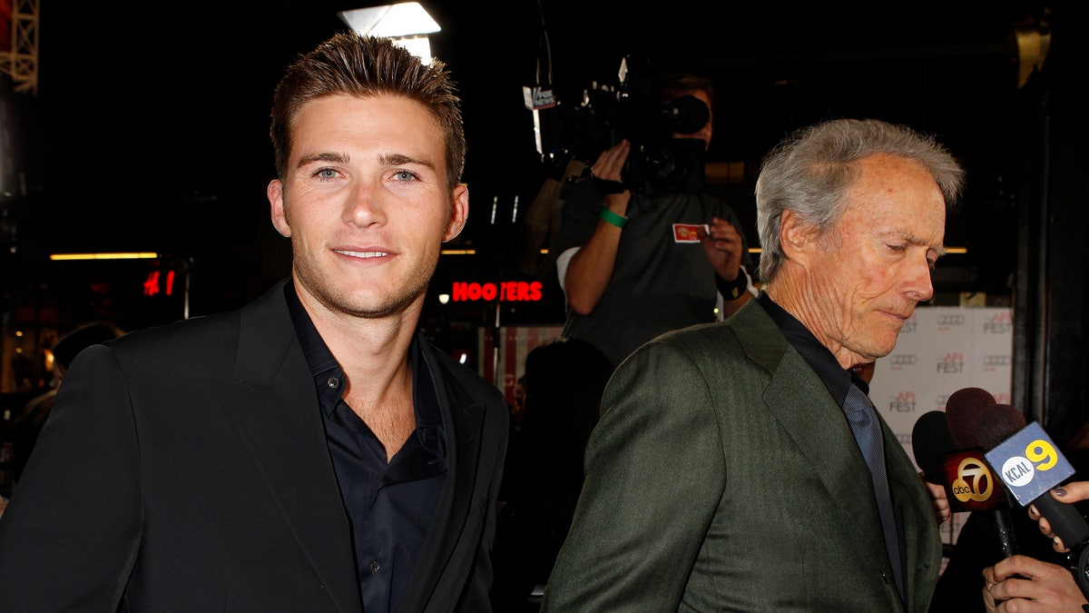 Director Clint Eastwood (R) is interviewed with his son Scott Eastwood at his side, at the opening night gala for AFI Fest 2011 with the premiere of Eastwood's film 