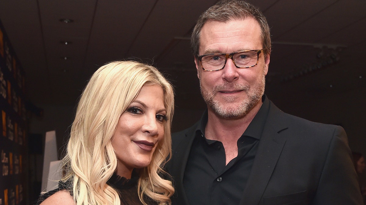 Tori Spelling and Dean McDermott smile in a photo