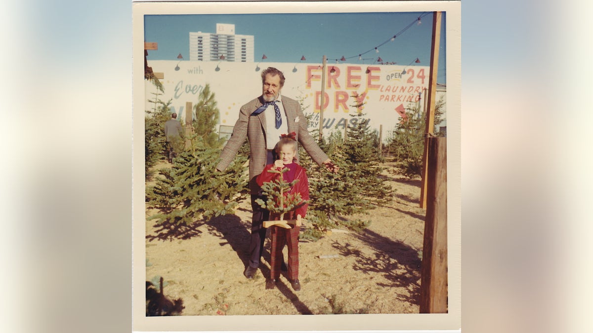 Vincent Price picking out a Christmas tree with daughter Victoria