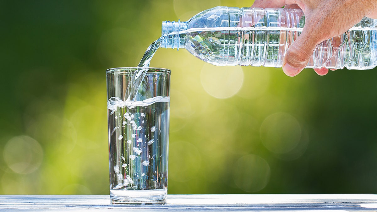 water is poured into a clear glass