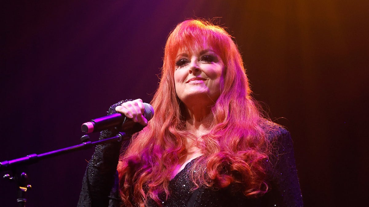 Country star Wynonna Judd holds a microphone