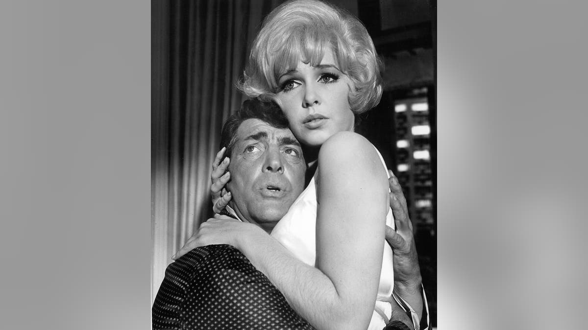 Dean Martin and Stella Stevens holding onto to each other in despair