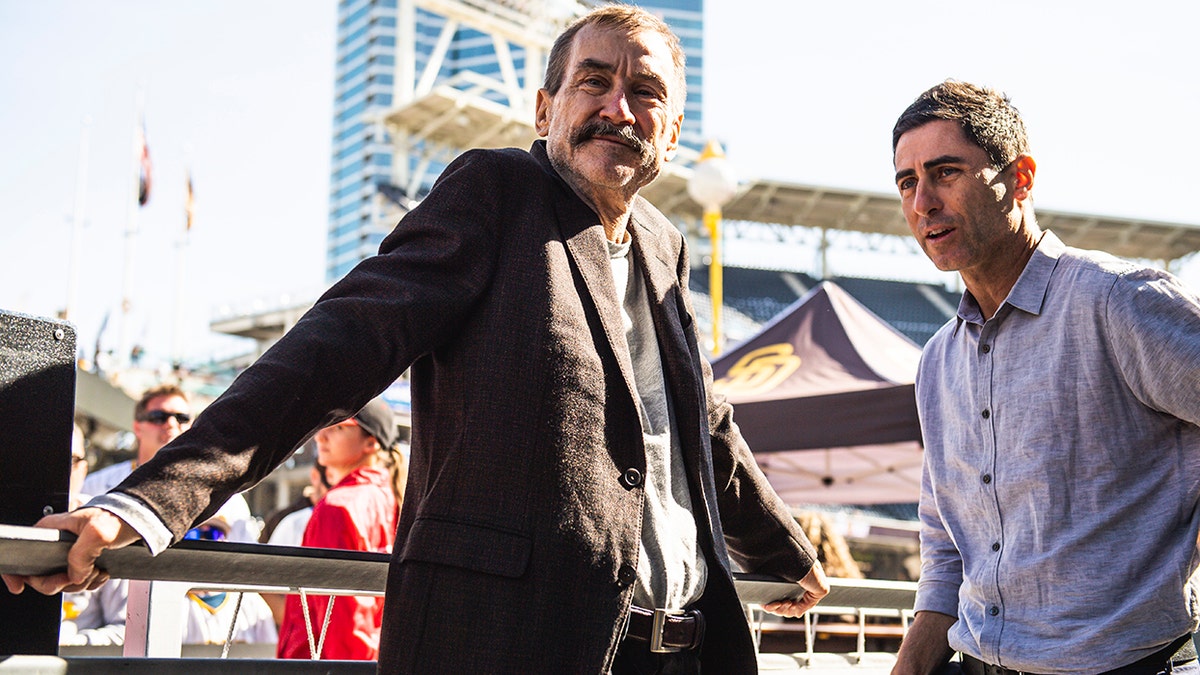 Peter Seidler and A.J. Preller look on