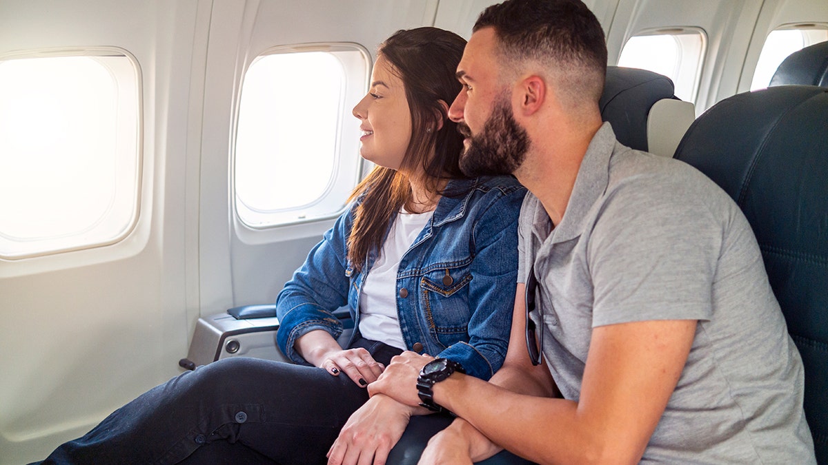 couple sitting together on plane after seat angel