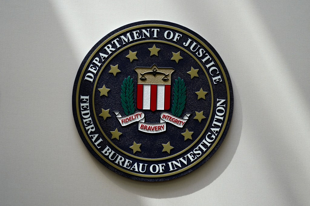 The FBI logo hangs on a wall in Omaha, Neb. on Aug. 10, 2022.