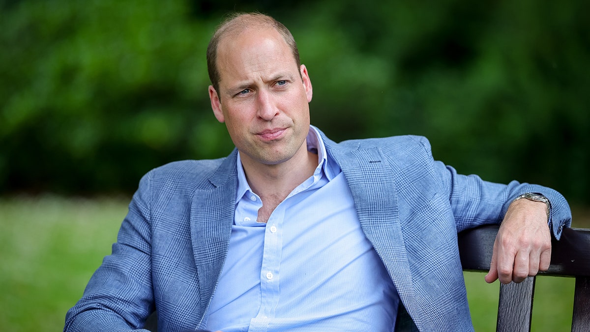 A close-up of Prince William wearing a light blue blazer and a matching shirt.