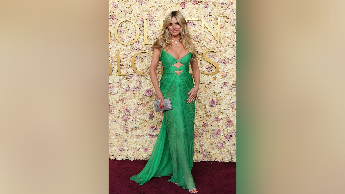 Heidi Klum walked the carpet at the 2025 Golden Globes in a green dress with cutouts.