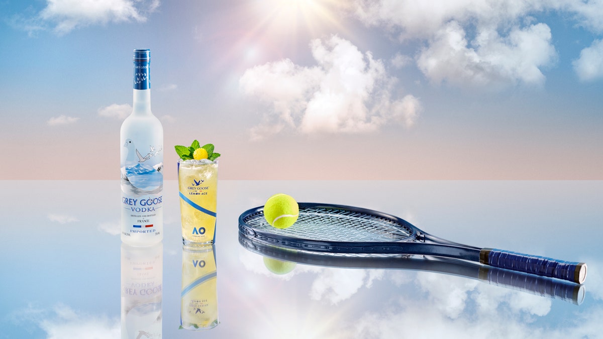 A bottle of Grey Goose Vodka is shown next to a glass of the Australian Open's Lemon Ace, a tennis ball and a tennis racket in the clouds.