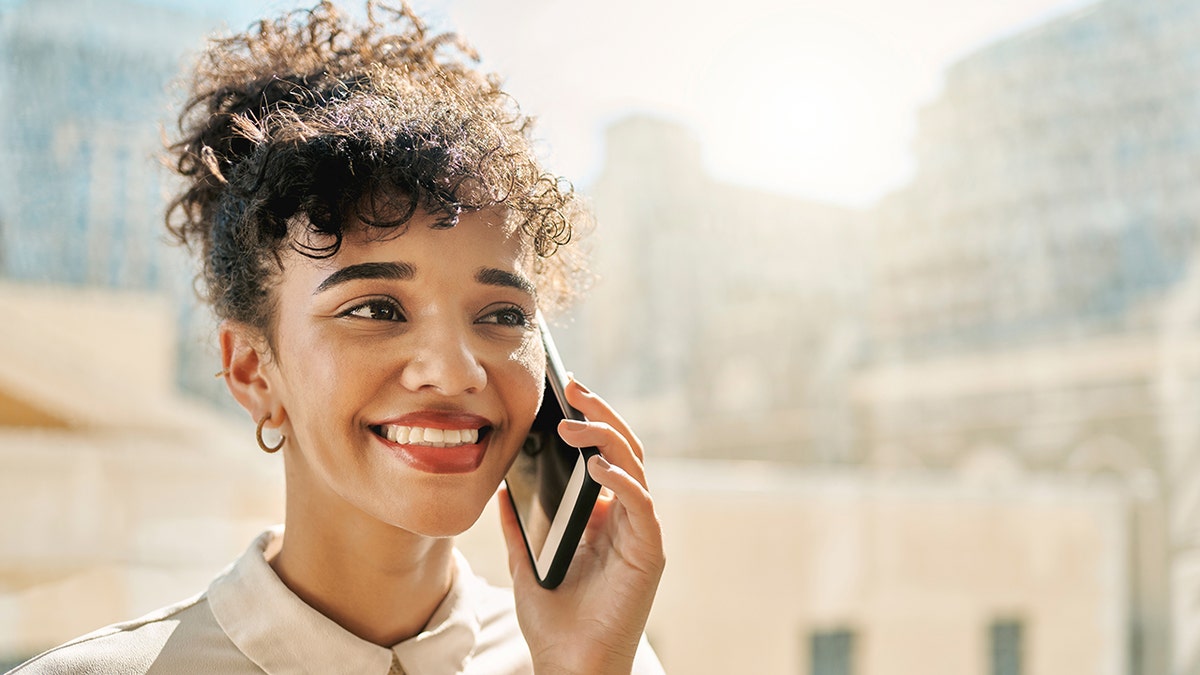 woman smiling on a phone call