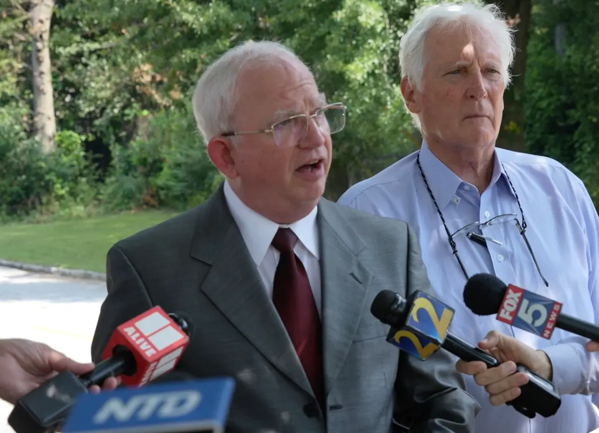 John Eastman (L), former attorney and adviser for former President Donald Trump, speaks with reporters along with his attorney, L. David Wolfe, outside the Fulton County Jail on Aug. 22, 2023, in a still from a video. (NTD/Screenshot via The Epoch Times)