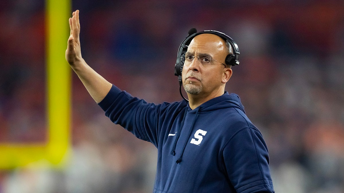 James Franklin with hand up on field