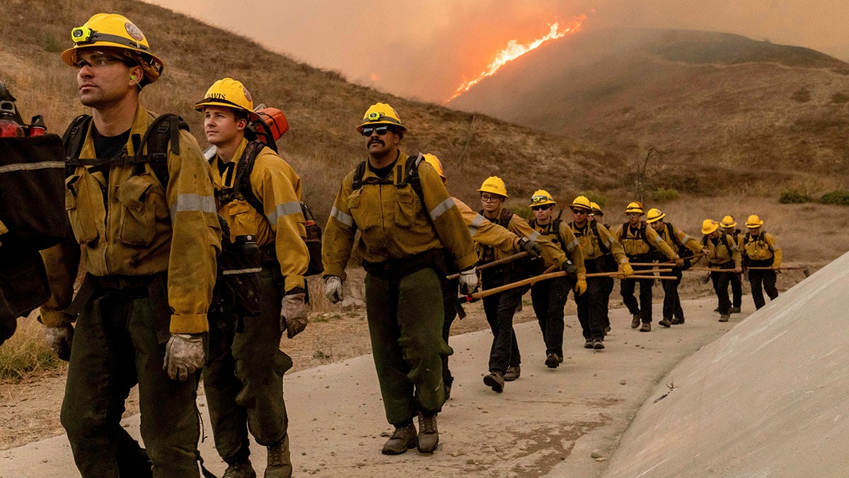 firefighters walk near the Kenneth Fire in LA