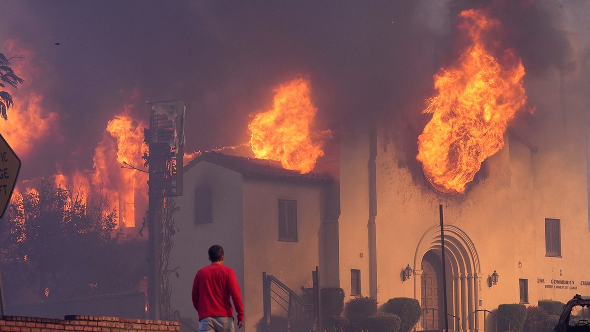 CA man walks by burning church