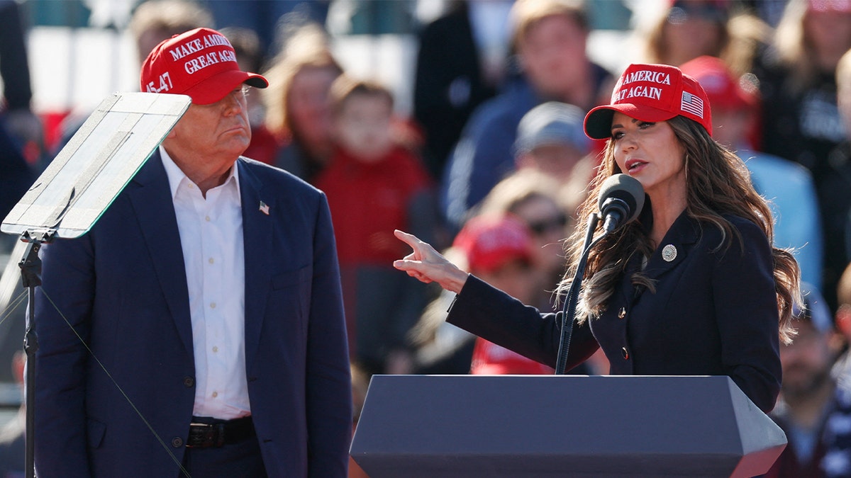 Kristi Noem at lectern with Trump to her side