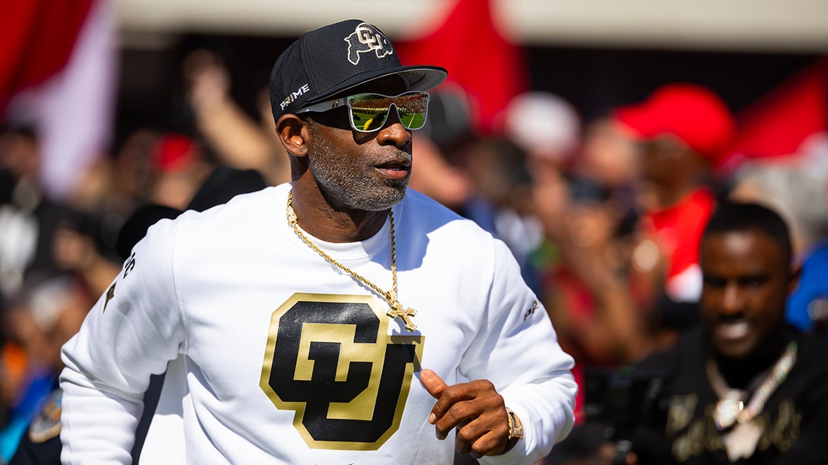 Deion Sanders runs on field