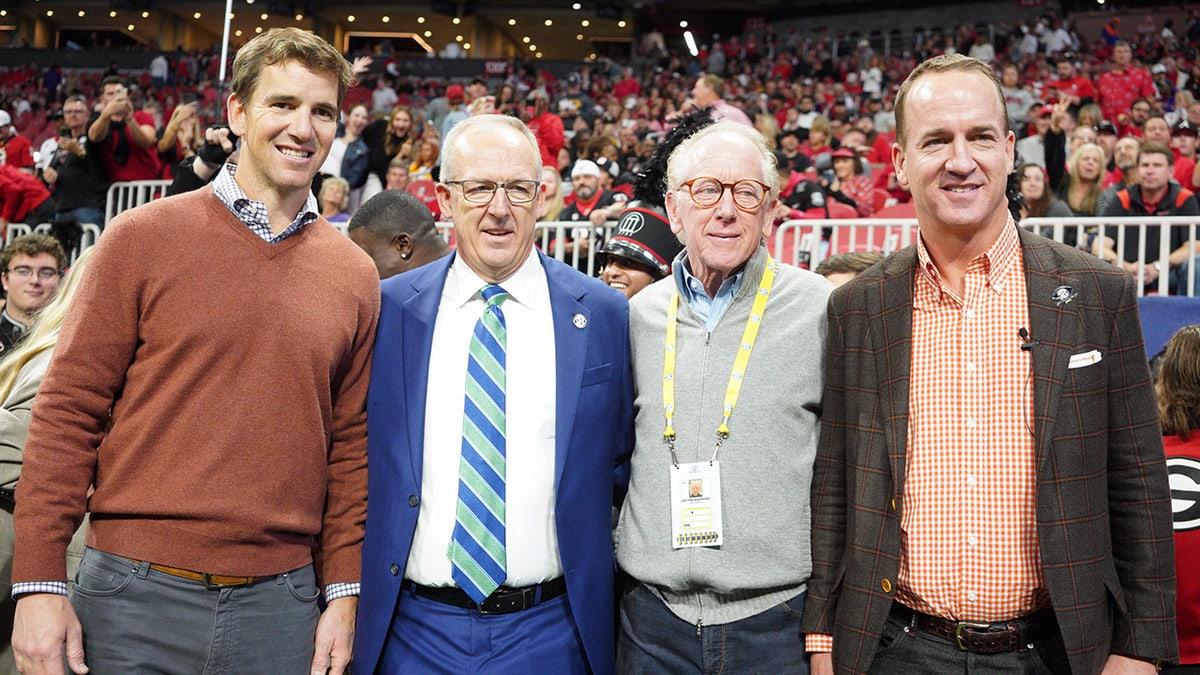 Eli Manning, Greg Sankey, Archie Manning, Peyton Manning pose