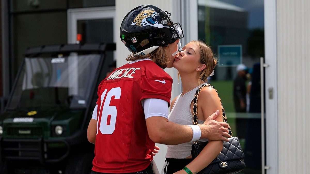 Trevor Lawrence kisses wife