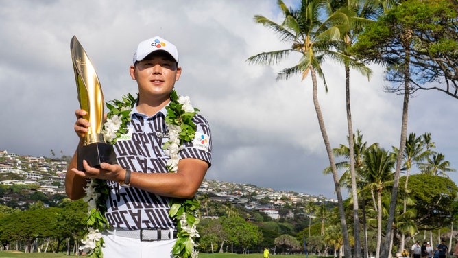 Si Woo Kim poses with the trophy after winning the 2023 Sony Open at Waialae Country Club. (Kyle Terada-USA TODAY Sports)